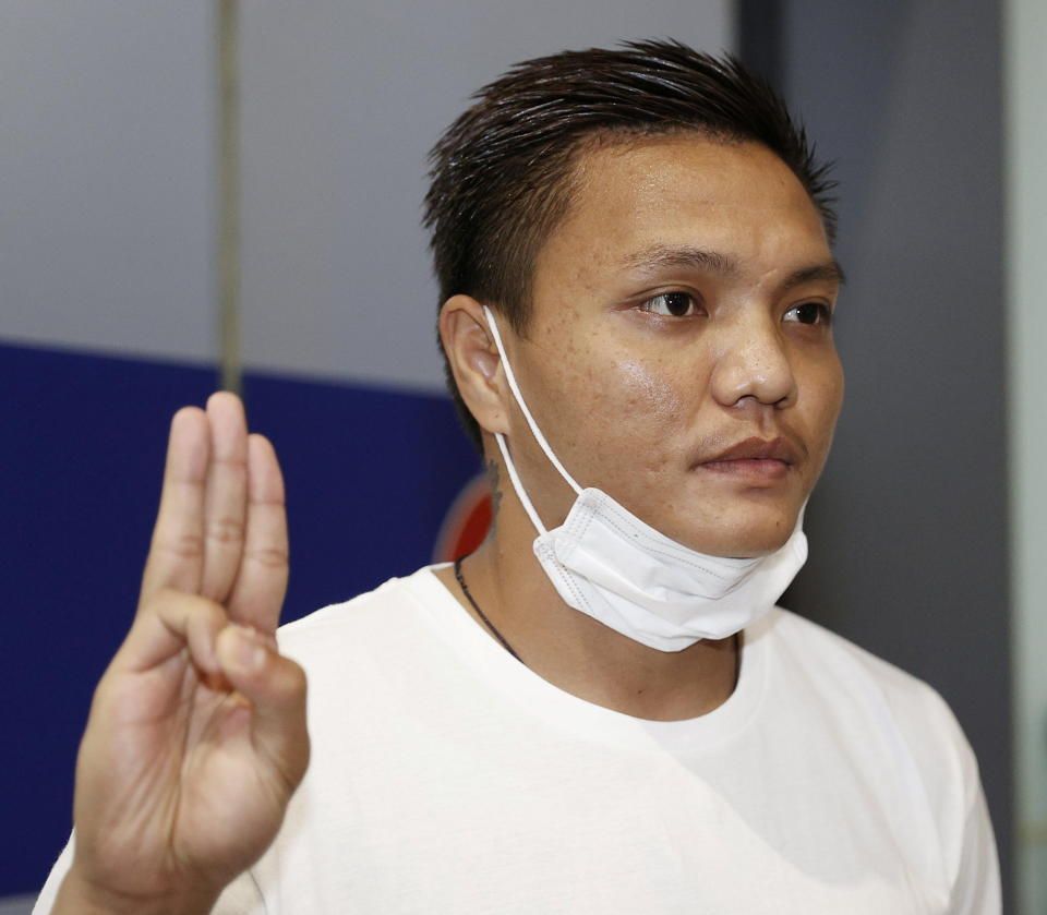 Pyae Lyan Aung, a Myanmar national football substitute goalkeeper, shows a three-finger salute after intending to seek refugee asylum at Kansai International Airport in Osaka Prefecture, Japan June 17, 2021, in this photo taken by Kyodo. Kyodo/via REUTERS ATTENTION EDITORS - THIS IMAGE WAS PROVIDED BY A THIRD PARTY. MANDATORY CREDIT. JAPAN OUT.