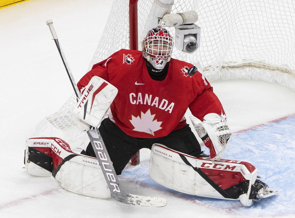 FILE - Canada goalie Devon Levi makes a save against Russia during third-period IIHF World Junior Hockey Championship action in Edmonton, Alberta, Monday, Jan. 4, 2021. The Buffalo Sabres signed goalie Devon Levi to a three-year entry level contract on Friday, March 17, 2023, less than a week after the 21-year-old's junior season ended at Northeastern University.(Jason Franson/The Canadian Press via AP, File)