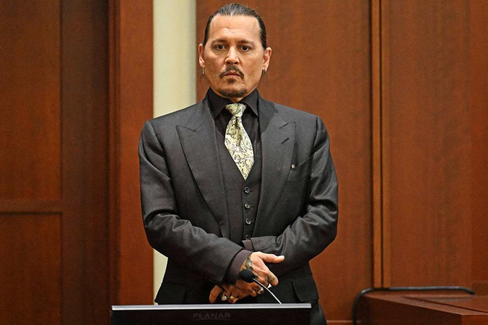 US actor Johnny Depp testifies during his defamation trial in the Fairfax County Circuit Courthouse in Fairfax, Virginia, on April 19, 2022. - Depp is suing ex-wife Amber Heard for libel after she wrote an op-ed piece in The Washington Post in 2018 referring to herself as a public figure representing domestic abuse. (Photo by JIM WATSON / POOL / AFP) (Photo by JIM WATSON/POOL/AFP via Getty Images)