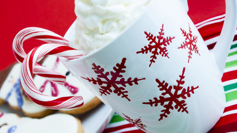 Mug of hot chocolate with whipped cream and candy canes