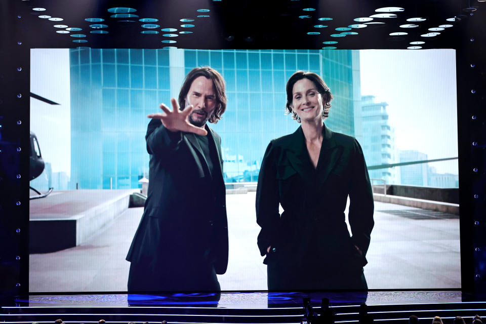 LOS ANGELES, CALIFORNIA - DECEMBER 09: (L-R) Keanu Reeves and Carrie-Anne Moss speak onscreen during The Game Awards 2021 at Microsoft Theater on December 09, 2021 in Los Angeles, California. (Photo by Kevin Winter/Getty Images)