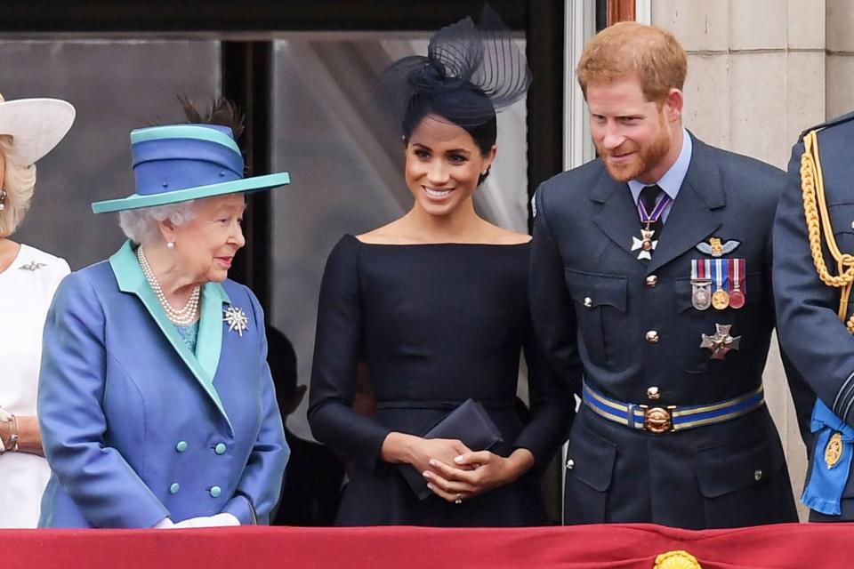 Prince Harry and Meghan Markle smile with the Queen while celebrating the 100th Anniversary of the Royal Air Force in July 2018.