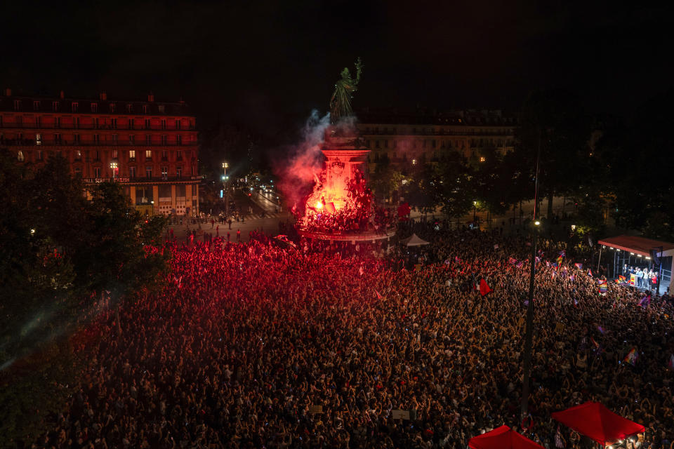 People gather at Republique plaza to protest the far-right National Rally, which came out strongly ahead in first-round legislative elections, Sunday, June 30, 2024, in Paris. France's high-stakes legislative elections propelled the far-right National Rally to a strong but not decisive lead in the first-round vote Sunday, polling agencies projected, dealing another slap to centrist President Emmanuel Macron. (AP Photo/Louise Delmotte)