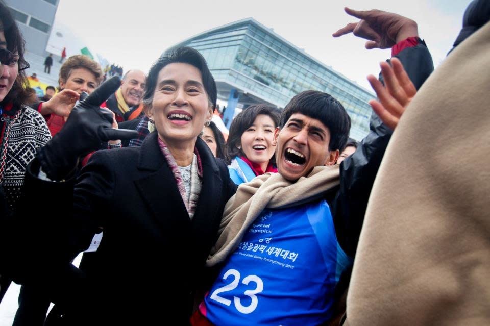 Nobel Peace Prize winner Aung San Suu Kyi celebrates with Bahrat athlete Dev Anil Dhingra after a snowshoe race.