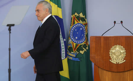 Brazil's President Michel Temer leaves after delivering a speech after deputies of the lower chamber of Brazil's Congress voted to reject a corruption charge against him at the Planalto Palace in Brasilia, Brazil August 2, 2017. REUTERS/Adriano Machado