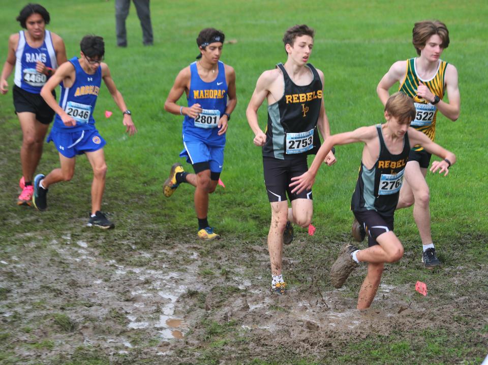 Runners in the Boys Varsity II race navigate the mud during the Section 1 Coaches Cross-Country Invitational at Bowdoin Park in Wappingers Falls Oct. 21, 2023.