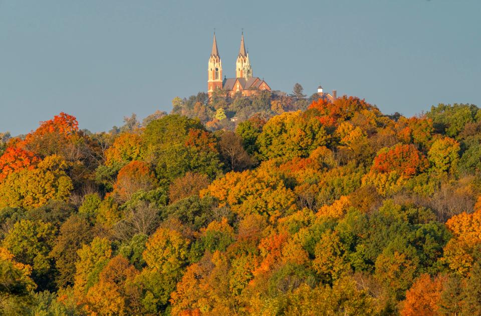 A canopy of fall colored trees surround the Basilica and National Shrine of Mary Help of Christians at Holy Hill in Hubertus on Sunday, Oct. 9, 2022.