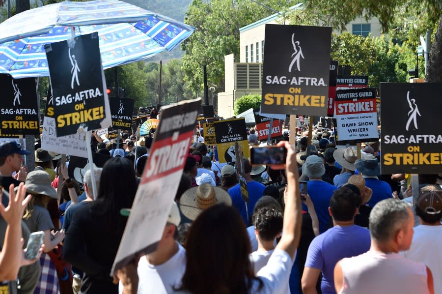 Attendees march at the Day of Solidarity union rally on Tuesday, Aug. 22, 2023, at Disney Studios in Burbank, Calif. The event includes members of SAG-AFTRA, the WGA and the AFL-CIO. (Photo by Jordan Strauss/Invision/AP)