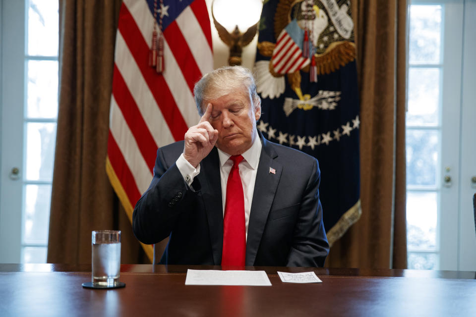President Donald Trump looks at his notes before speaking during an event on human trafficking in the Cabinet Room of the White House, Friday, Feb. 1, 2019, in Washington. (AP Photo/ Evan Vucci)