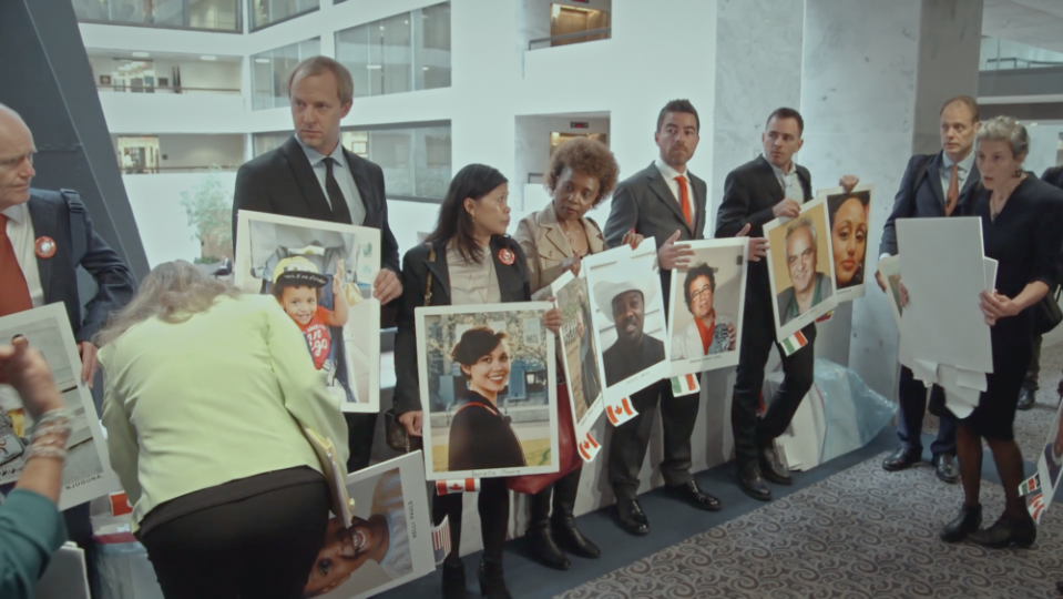 Family members of people killed in crashes of Boeing 737 Max aircraft hold up photos of their loved ones