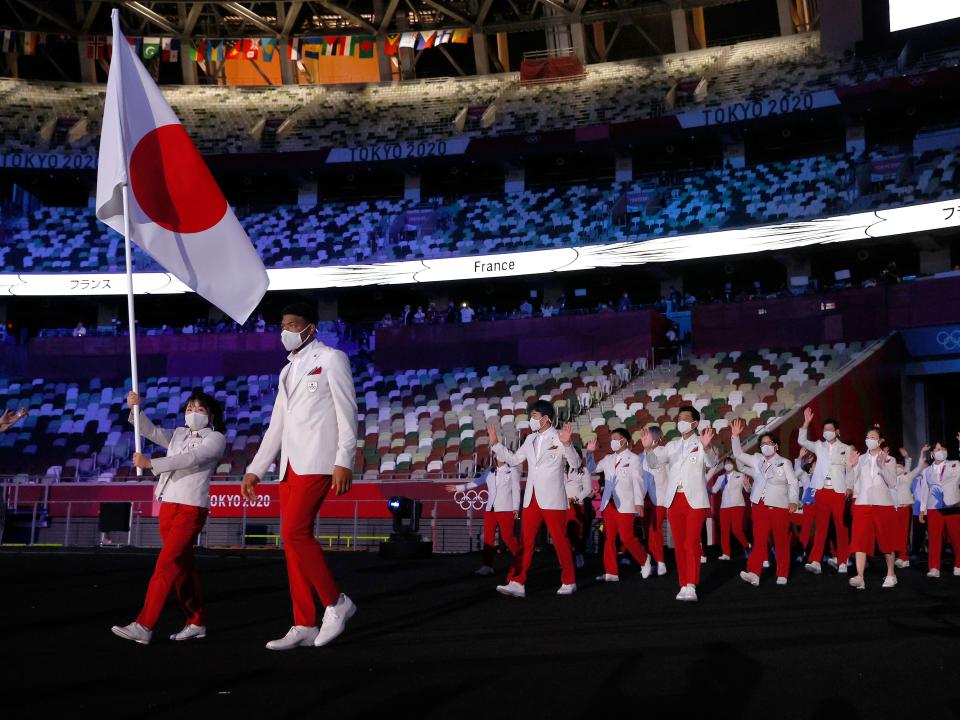 japan olympic team entering the parade of nations during the opening ceremony in 2021