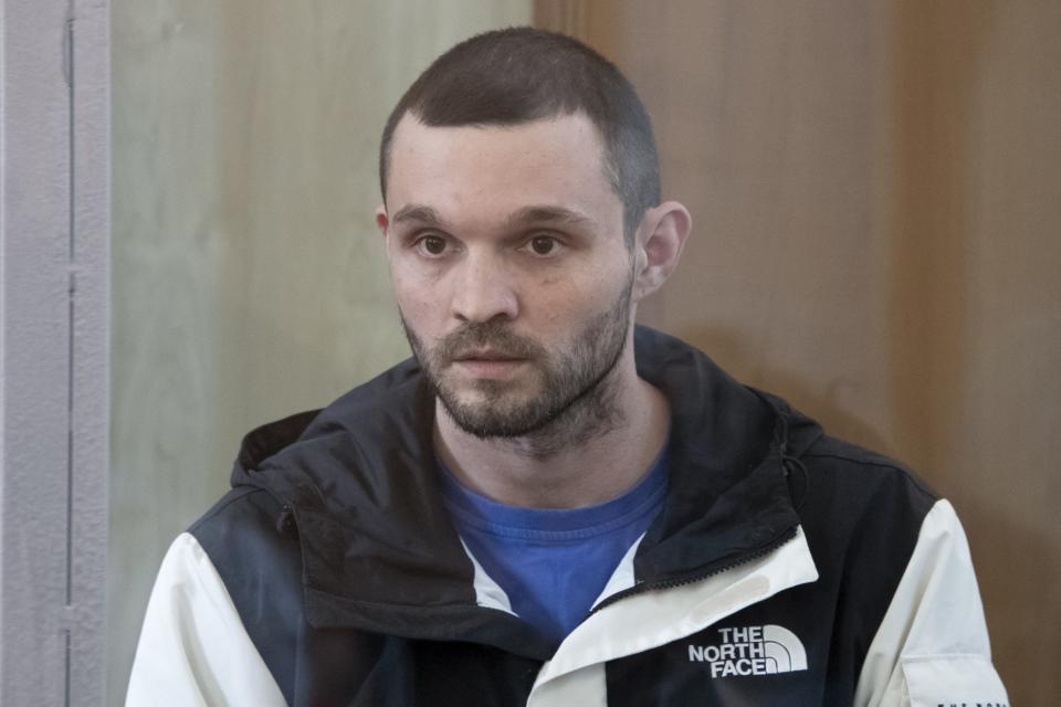 U.S. Army Staff Sgt. Gordon Black sits in a glass cage in courtroom in Vladivostok, Russia, on Wednesday, June 19, 2024. Black is on trial on charges of theft and threatening murder in a dispute with a Russian woman. Russian state media reported that he denied the allegation of threatening murder but "partially" admitted to theft. (AP Photo)