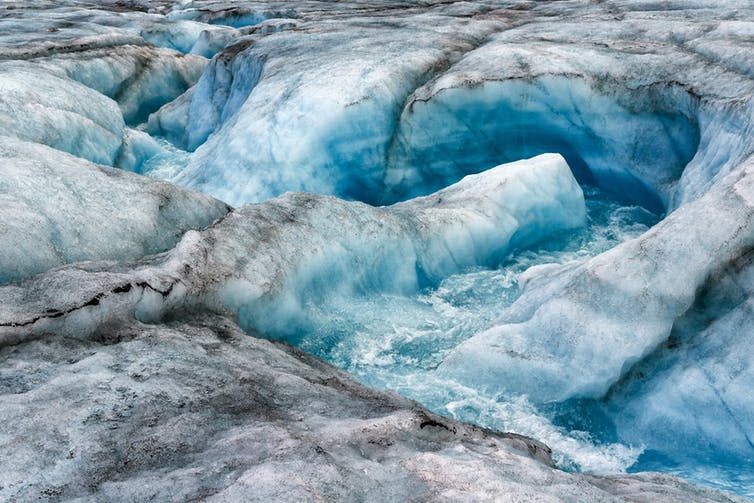 <span class="caption">Though invisible from the surface, melting within the ice can speed up the process by which ice sheets slide towards the sea.</span> <span class="attribution"><a class="link " href="https://www.shutterstock.com/image-photo/glacier-serpimolot-bay-bear-on-northern-384912739" rel="nofollow noopener" target="_blank" data-ylk="slk:Gans33/Shutterstock;elm:context_link;itc:0;sec:content-canvas">Gans33/Shutterstock</a></span>