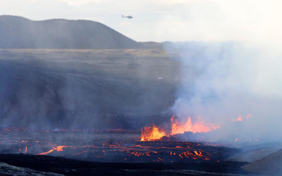 Spectators flock to dramatic volcanic eruption in Iceland - Brynjar Gunnarsson /AP