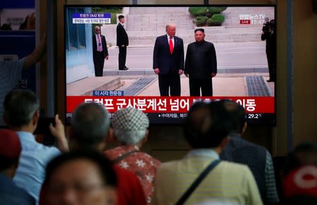South Korean people watch a live broadcast on a meeting between North Korean leader Kim Jong Un and U.S. President Donald Trump at the truce village of Panmunjom inside the demilitarised zone separating the two Koreas, in Seoul