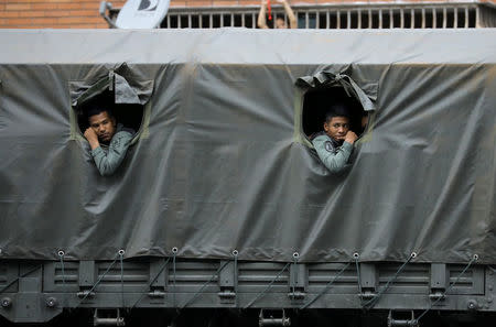 Riot security forces look on while waiting during a rally against President Nicolas Maduro in Caracas, Venezuela. REUTERS/Carlos Barria