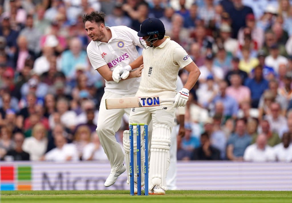 Pitch invader Daniel Jarvis, left, collides with England batsman Jonny Bairstow (Adam Davy/PA) (PA Wire)