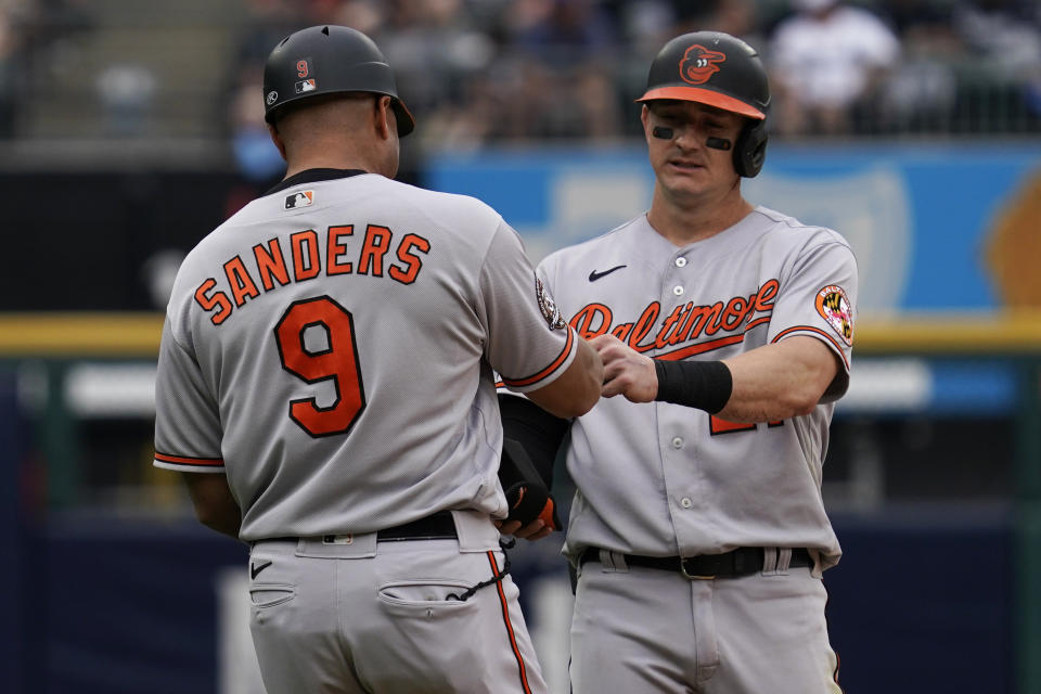 Baltimore Orioles' Austin Hays, right, celebrates with first base coach Anthony Sanders after hitting a three-run double during the seventh inning of a baseball game against the Chicago White Sox in Chicago, Saturday, June 25, 2022. (AP Photo/Nam Y. Huh)