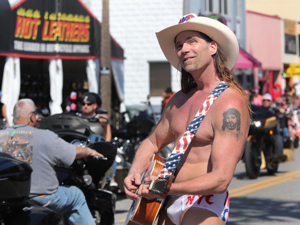 The Naked Cowboy joins the Main Street circus, Friday afternoon, March 4, 2022, on the first day of Bike Week 2022.