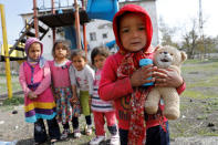 Afghan migrant children pose as they play in front of their homes in Kars, eastern Turkey, April 11, 2018. Picture taken April 11, 2018. REUTERS/Umit Bektas