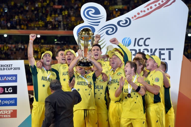 Australia's captain Michael Clarke (C) lifts the Cricket World Cup trophy after their final victory against New Zealand, in Melbourne, on March 29, 2015