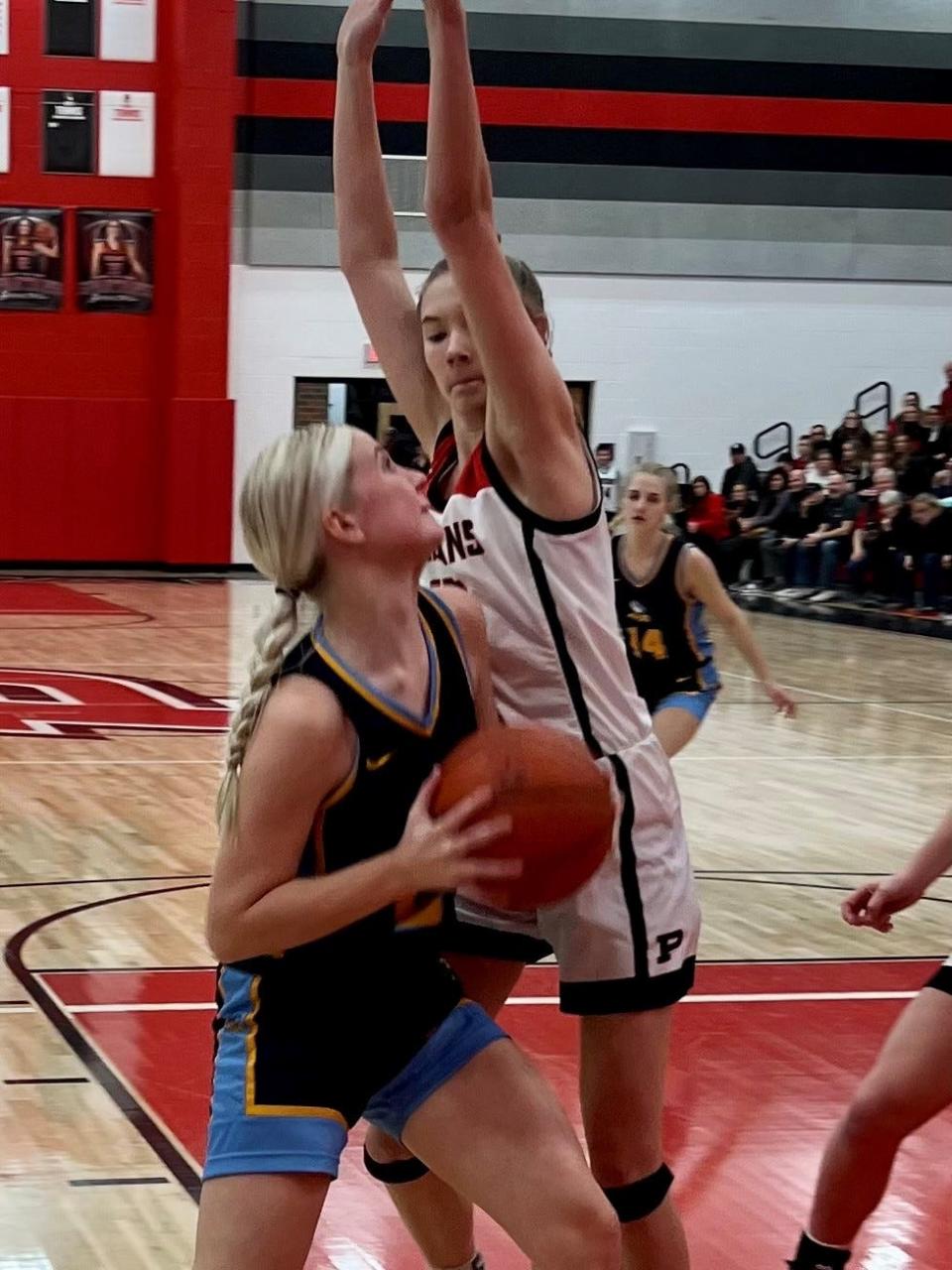 River Valley's Lexie Hecker goes up for a shot against Pleasant's Avah Steele during a girls basketball game earlier this season at Pleasant.