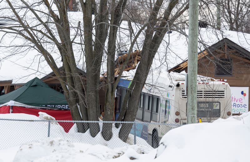 A Laval city bus is seen crashed into a daycare in Laval, Quebec
