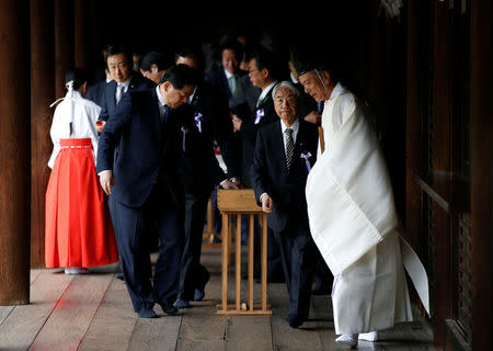 A group of lawmakers including Japan's ruling Liberal Democratic Party (LDP) lawmaker Hidehisa Otsuji are led by a Shinto priest as they visit Yasukuni Shrine in Tokyo, Japan April 21, 2017. REUTERS/Toru Hanai