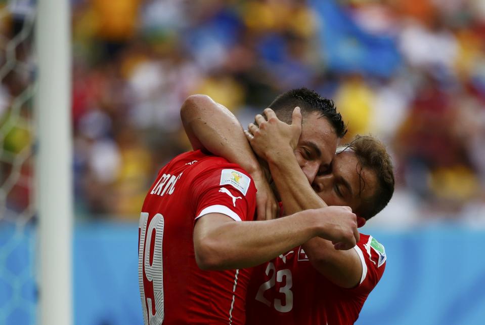 Switzerland's Xherdan Shaqiri (R) celebrates with Josip Drmic after scoring against Honduras during their 2014 World Cup Group E soccer match at the Amazonia arena in Manaus June 25, 2014. REUTERS/Michael Dalder (BRAZIL - Tags: SOCCER SPORT WORLD CUP)