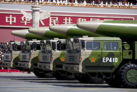 FILE PHOTO - Military vehicles carrying DF-26 ballistic missiles travel past Tiananmen Gate during a military parade to commemorate the 70th anniversary of the end of World War II in Beijing Thursday Sept. 3, 2015. Andy Wong/Pool via REUTERS/File Photo