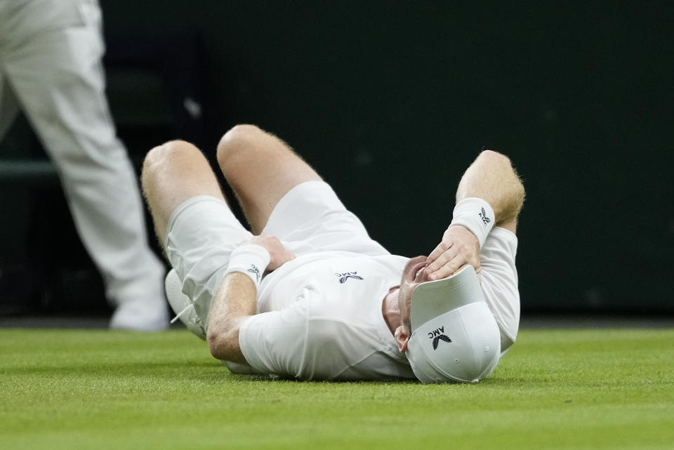 Britain's Andy Murray reacts after slipping and falling trying to play a shot to Stefanos Tsitsipas of Greece in a men's singles match on day four of the Wimbledon tennis championships in London, Thursday, July 6, 2023. (AP Photo/Kirsty Wigglesworth)