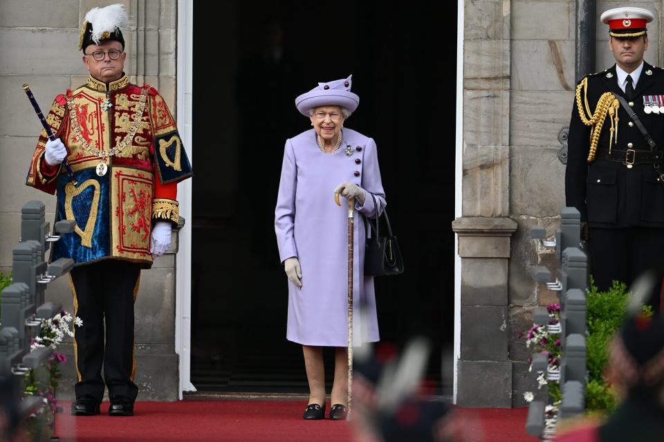 Queen Elizabeth II (C) attends an Armed Forces Act of Loyalty Parade at the Palace of Holyroodhouse