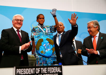 German President Frank-Walter Steinmeier and COP23 President Prime Minister Frank Bainimarama of Fiji greet teenager Timothy Naulusala from Fiji after his speech as U.N. Secretary-General Antonio Guterres looks on during COP23 U.N. Climate Change Conference in Bonn, Germany, November 15, 2017. REUTERS/Wolfgang Rattay