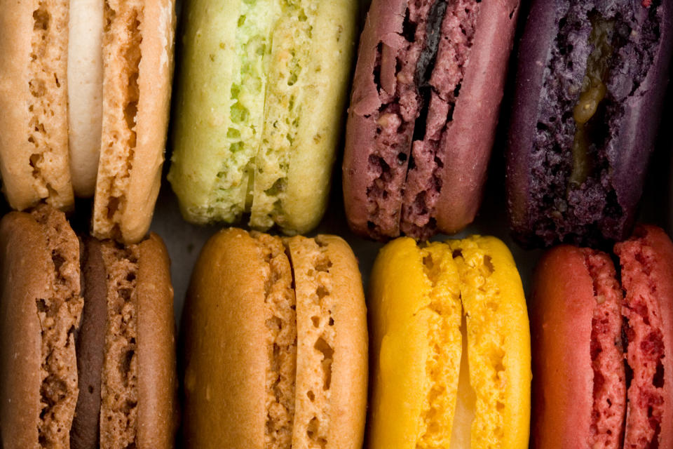 Various macarons arranged in two rows, with different flavors