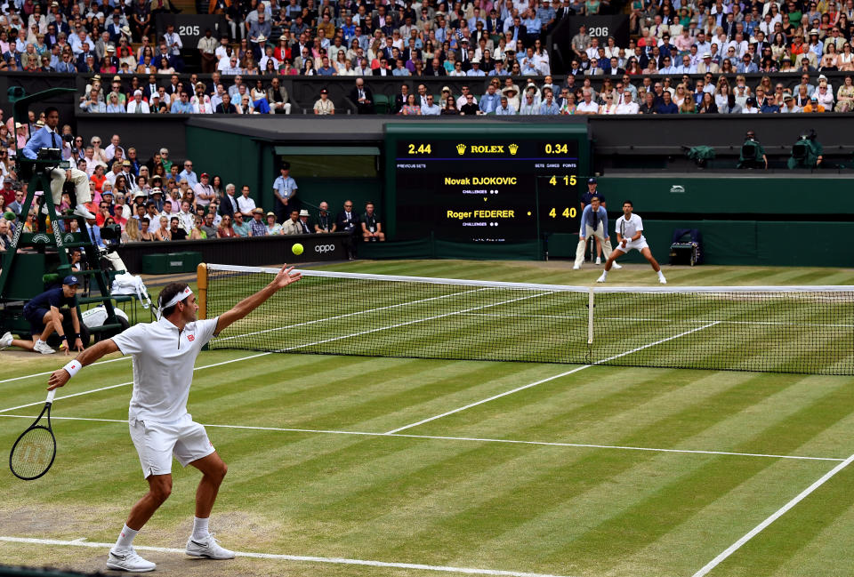Roger Federer and Novak Djokovic (top) in action in the mens singles final on day thirteen of the Wimbledon Championships at the All England Lawn Tennis and Croquet Club, Wimbledon.