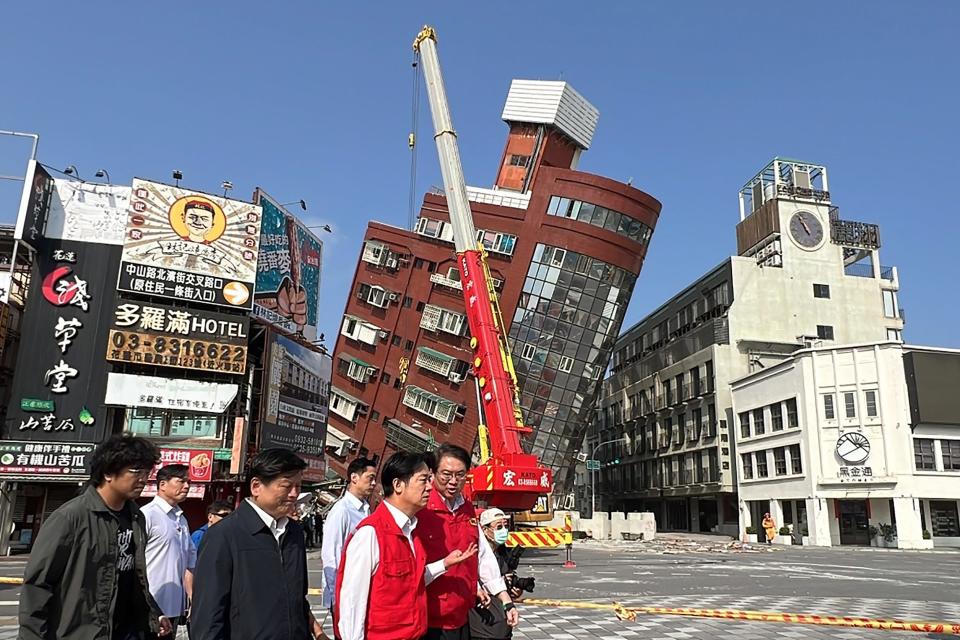 This photo taken by Taiwan's Central News Agency (CNA) on April 3, 2024 shows Taiwan's president-elect and current Vice-President Lai Ching-te (3rd R) surveying damage in Hualien, after a major earthquake hit Taiwan's east. At least seven people were killed and more than 700 injured on April 3 by a powerful earthquake in Taiwan that damaged dozens of buildings and prompted tsunami warnings that extended to Japan and the Philippines before being lifted.