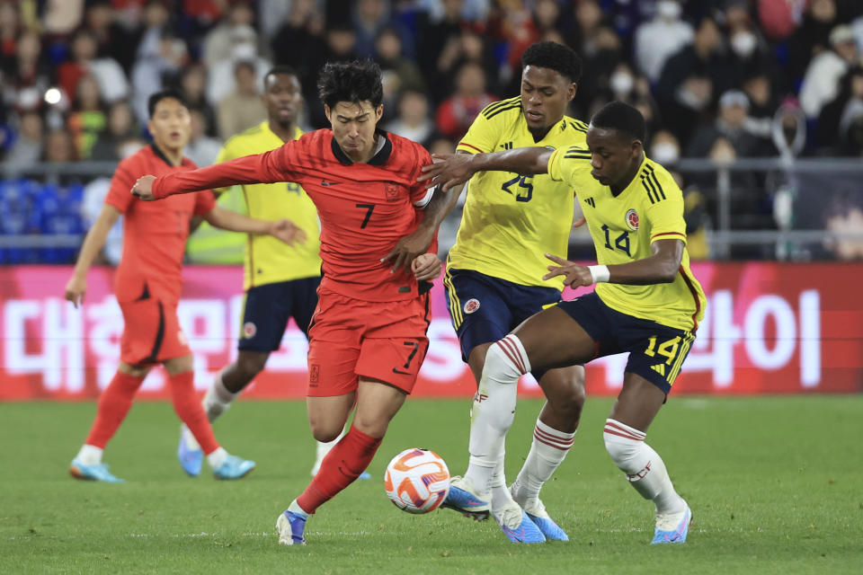 South Korea's Son Heung-min fights for the ball against Colombia's Jhon Jader Duran, right, and Colombia's Nelson Palacio during their friendly soccer match between South Korea and Colombia in Ulsan, South Korea, Friday, March 24, 2023. (Kim Do-hun/Yonhap via AP)