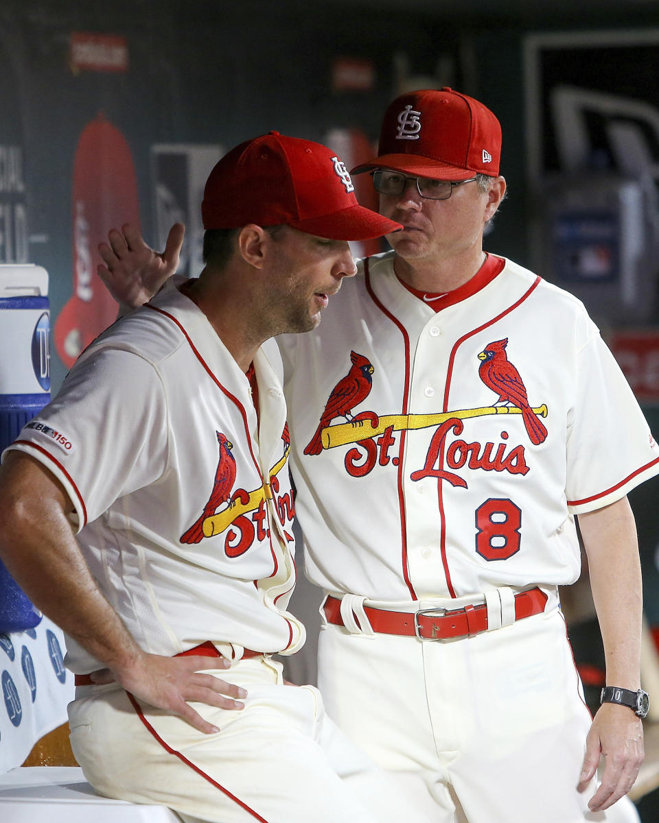 St. Louis Cardinals manager Mike Shildt (8), right, talks with starting pitcher Adam Wainwright (50) after Wainwright was pulled from the mound during the fifth inning of a baseball game against the Chicago Cubs, Saturday, Sept. 28, 2019, in St. Louis. (AP Photo/Scott Kane)