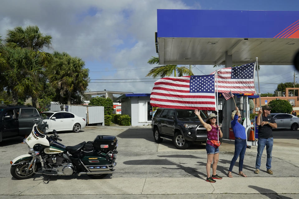 FILE - In this Dec. 31, 2020, file photo supporters of President Donald Trump watch as his motorcade passes by in West Palm Beach, Fla. (AP Photo/Patrick Semansky, File)
