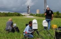 Photographers set up remote cameras as a SpaceX Falcon 9 rocket is prepared for another launch attempt for Polaris Dawn, a private human spaceflight mission