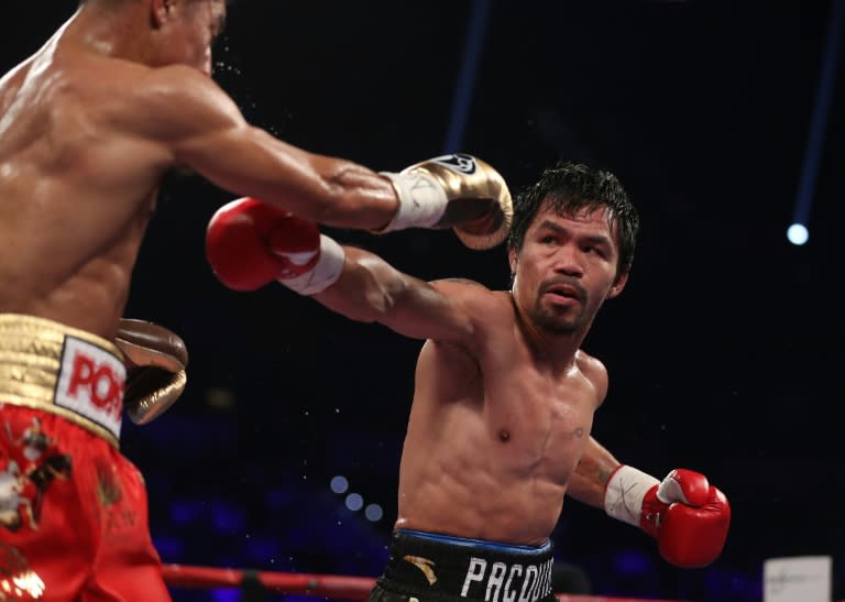 Manny Pacquiao (R) throws a right to the head of Jessie Vargas during their WBO welterweight championship fight, at the Thomas & Mack Center in Las Vegas, Nevada, on November 5, 2016