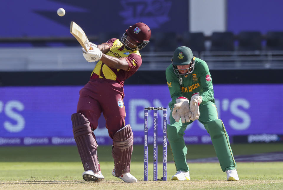 West Indies' Evin Lewis hits the ball for six runs during the Cricket Twenty20 World Cup match between South Africa and the West Indies in Dubai, UAE, Tuesday, Oct. 26, 2021. (AP Photo/Kamran Jebreili)