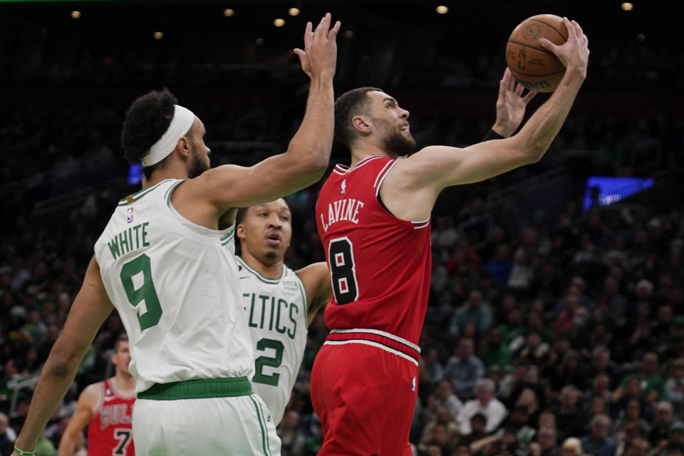 Chicago Bulls guard Zach LaVine (8) drives to the basket past Boston Celtics guard Derrick White (9) during the first half of an NBA basketball game, Monday, Jan. 9, 2023, in Boston. (AP Photo/Charles Krupa)