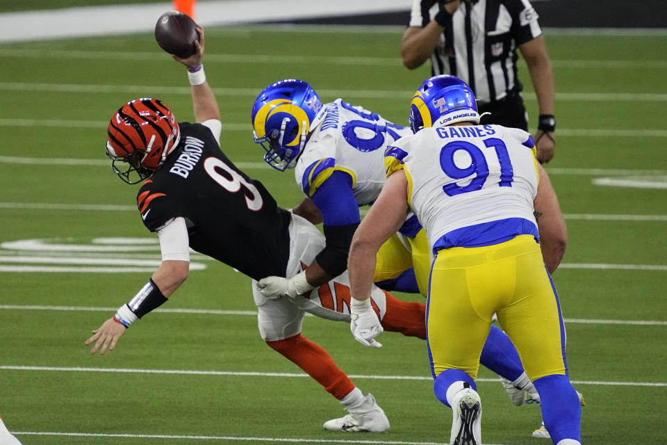 FILE - Los Angeles Rams defensive end Aaron Donald (99) tackles Cincinnati Bengals quarterback Joe Burrow (9) during the second half of the NFL Super Bowl 56 football game Sunday, Feb. 13, 2022, in Inglewood, Calif. The Bengals and Rams are set for a rematch for the first time in a regular season game since the Super Bowl. (AP Photo/Julio Cortez, File)