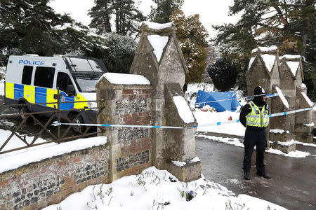 A police officer stands outside the London Road cemetery where the grave of Alexander Skripal; son of former Russian intelligence officer Sergei Skripal; is seen covered with a tent, in Salisbury, Britain, March 19, 2018. REUTERS/Peter Nicholls