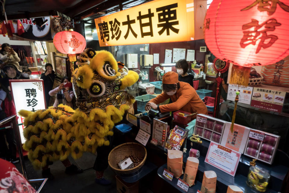 YOKOHAMA, JAPAN - JANUARY 25: A lion dance is performed outside a store in Yokohama China Town on January 25, 2020 in Yokohama, Japan. Thousands of people gathered in the largest Chinese community in Japan to celebrate the Chinese Lunar New Year of the Rat. (Photo by Tomohiro Ohsumi/Getty Images)