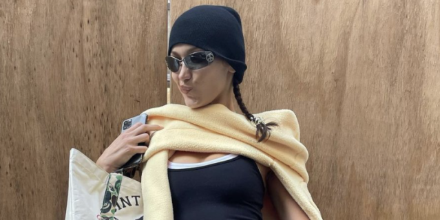 bella hadid keeps it trendy as she leaves her apartment with her