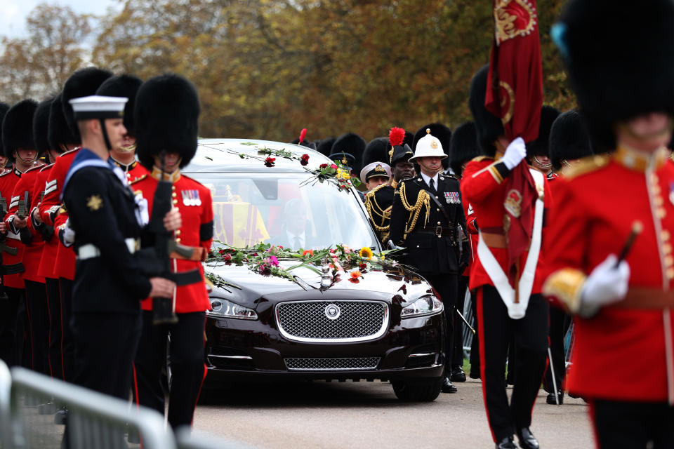 WINDSOR, ENGLAND - SEPTEMBER 19: The coffin of Queen Elizabeth II is carried in the State Hearse as it proceeds towards St. George's Chapel on September 19, 2022 in Windsor, England. The committal service at St George's Chapel, Windsor Castle, took place following the state funeral at Westminster Abbey. A private burial in The King George VI Memorial Chapel followed. Queen Elizabeth II died at Balmoral Castle in Scotland on September 8, 2022, and is succeeded by her eldest son, King Charles III. (Photo by Alex Pantling/Getty Images)