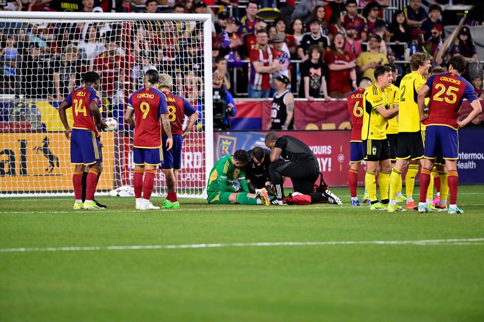 Apr 13, 2024; Sandy, Utah, USA; Columbus Crew goalkeeper Evan Bush (24) gets medical attention after a collision with Real Salt Lake midfielder Matt Crooks (25) during the first half at America First Field. Mandatory Credit: Christopher Creveling-USA TODAY Sports