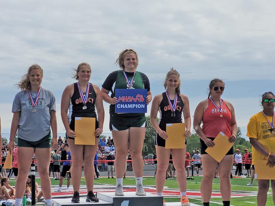 Quincy's Raigen Horsfall (second from left) and Sophia Snellenberger (third from right) both earned a pair of All State honors. Here they pose on the podium for the shot put where Horsfall took 2nd and Snellenberger finished 3rd